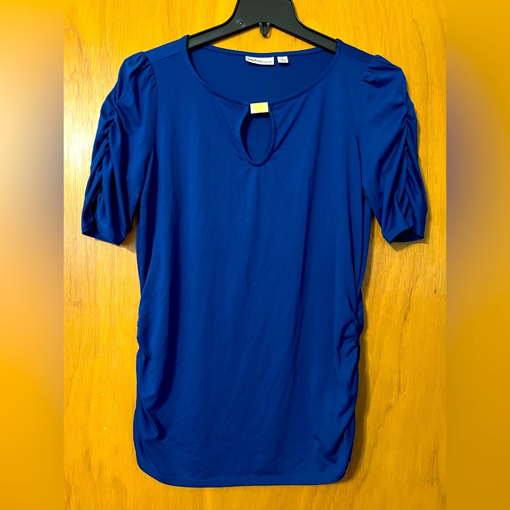 Blue knit top with ruched sleeves and decorative detail